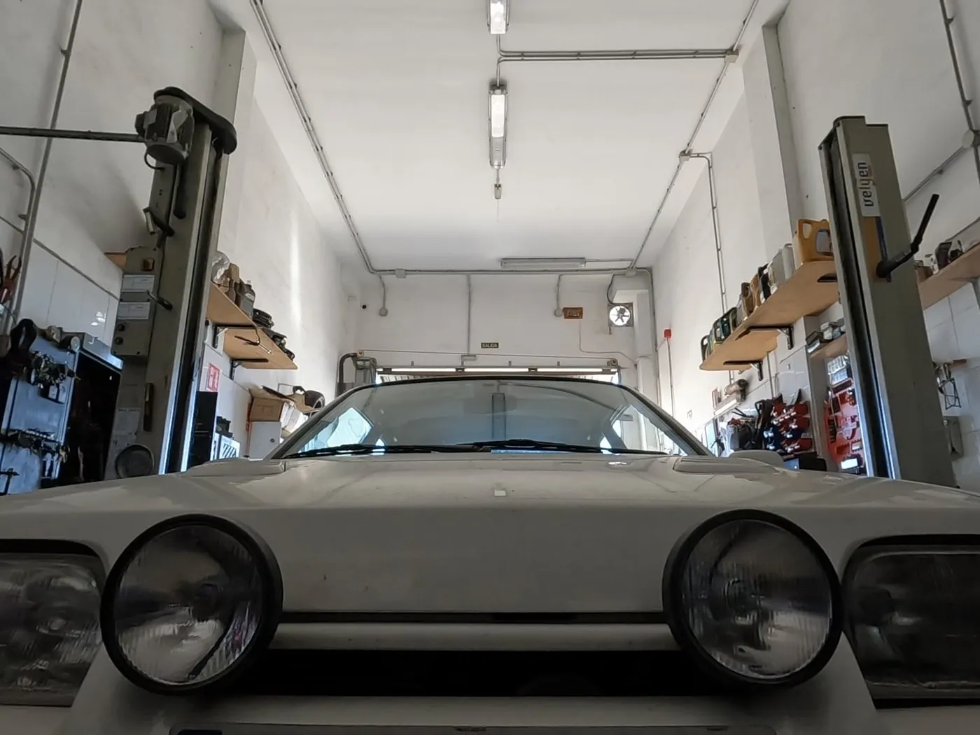 Front view of a vehicle on the lift inside the CSR Autos workshop.